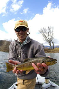 Clint Lensgraf, head of the Mahoney's Outfitters fly fishing department, holds a brown trout caught in the Watauga River. (Photo by Adam Campbell)