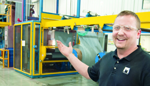 Travis Cunningham, production manager, points out a roll of Duroforce separator at Microporous’ Piney Flats, Tenn., manufacturing facility